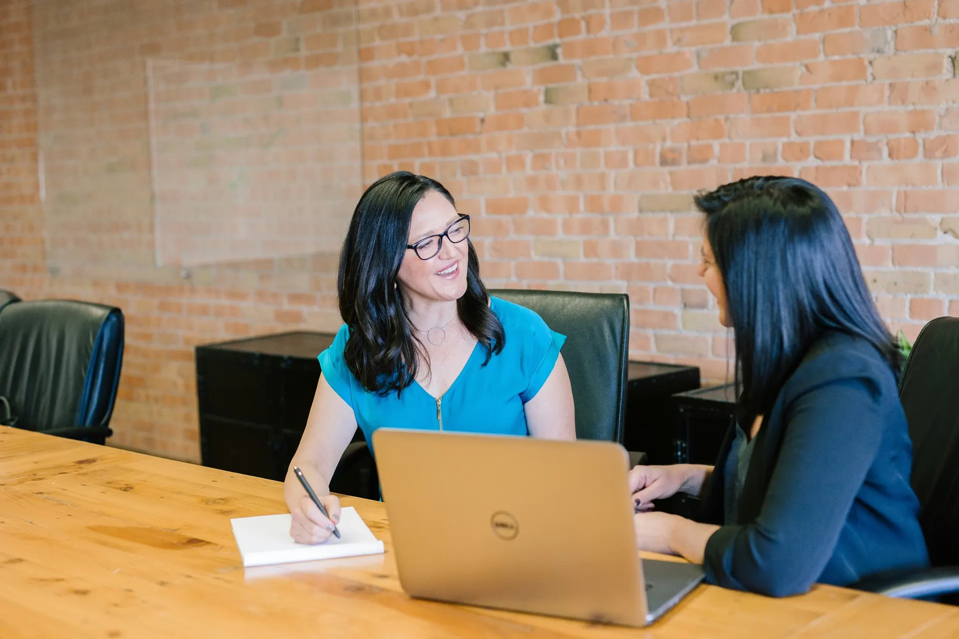 An adviser and a student reviewing an application together